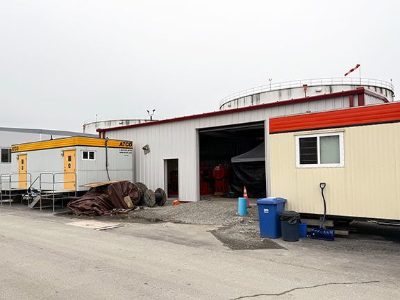 Completed YVR metal building completed by Double Black Construction among surrounding structures.