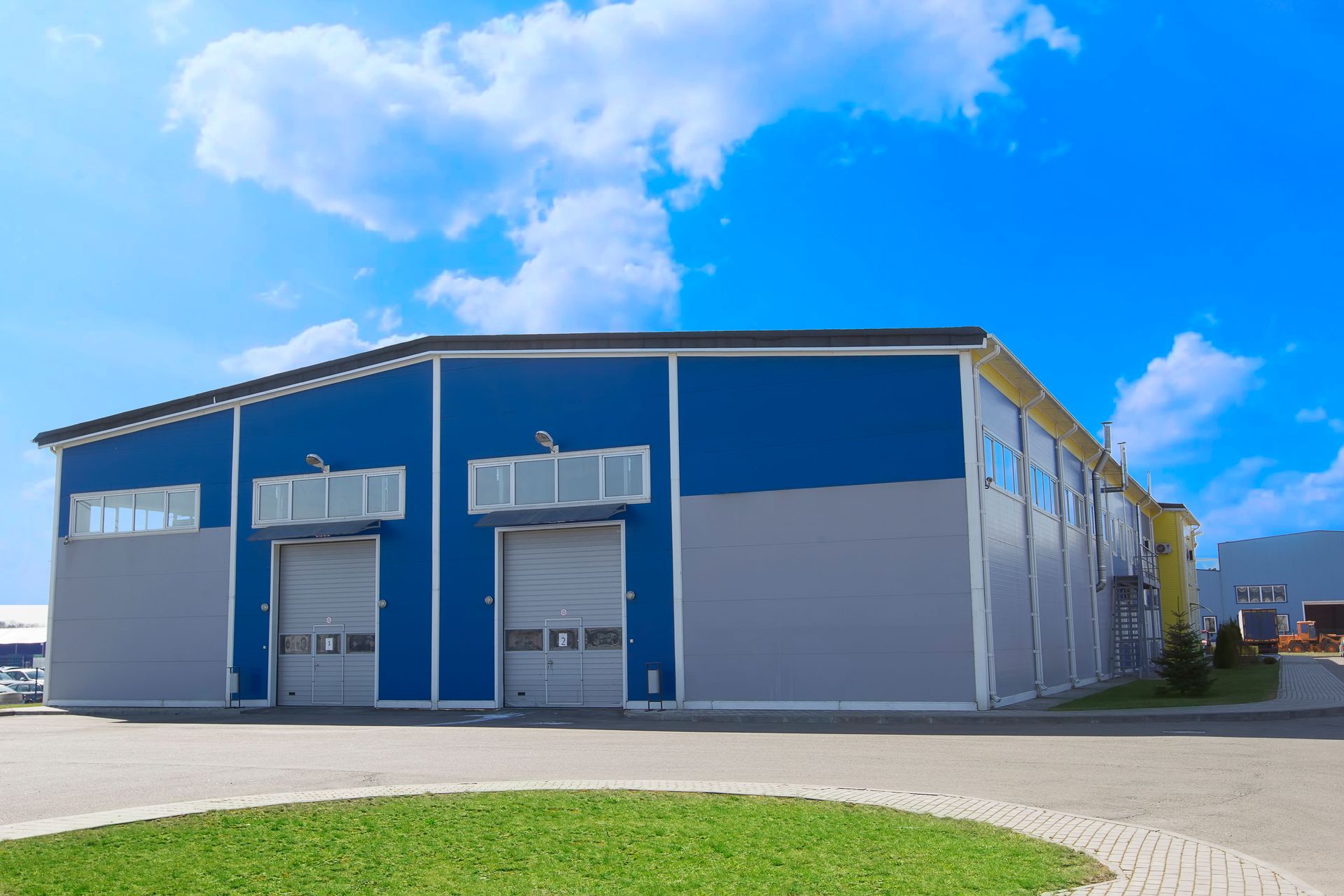 A large blue and gray building with a blue sky in the background.