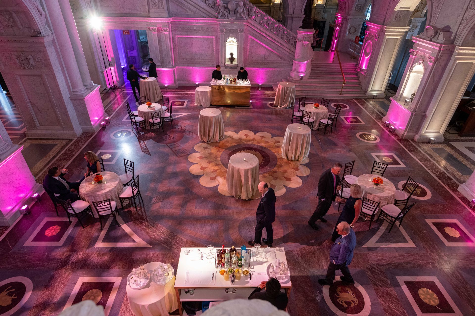 An aerial view of a large room filled with tables and chairs.