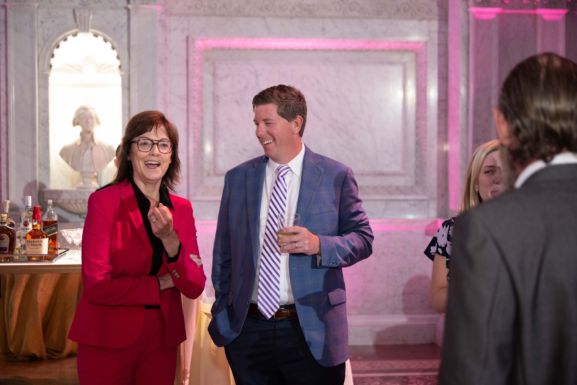 A man and a woman are standing next to each other in a room.