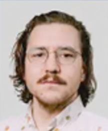 A man with glasses and a mustache is wearing a white shirt.
