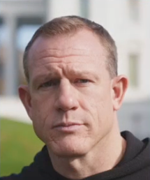 A close up of a man 's face with a serious look on his face