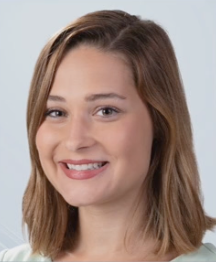 A woman with blonde hair is smiling for the camera