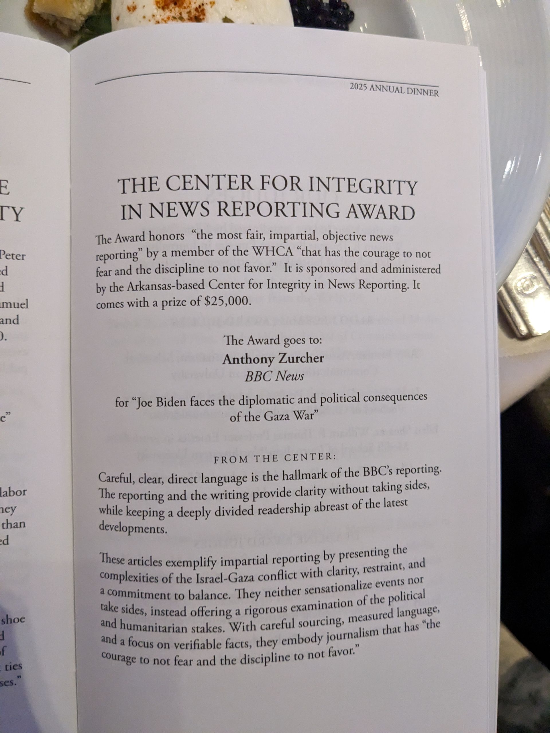 A book is open to a page that says the center for integrity in news reporting award