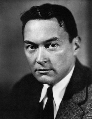 A black and white photo of a man in a suit and tie