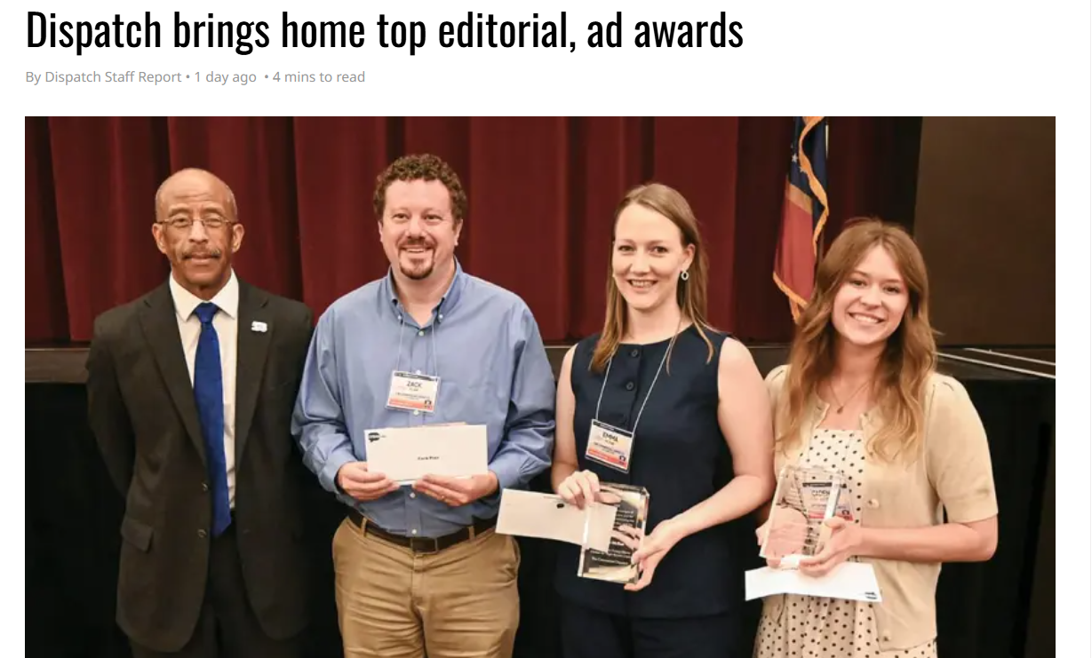 Four people pose with awards in front of a red curtain after a newspaper editorial honors ceremony