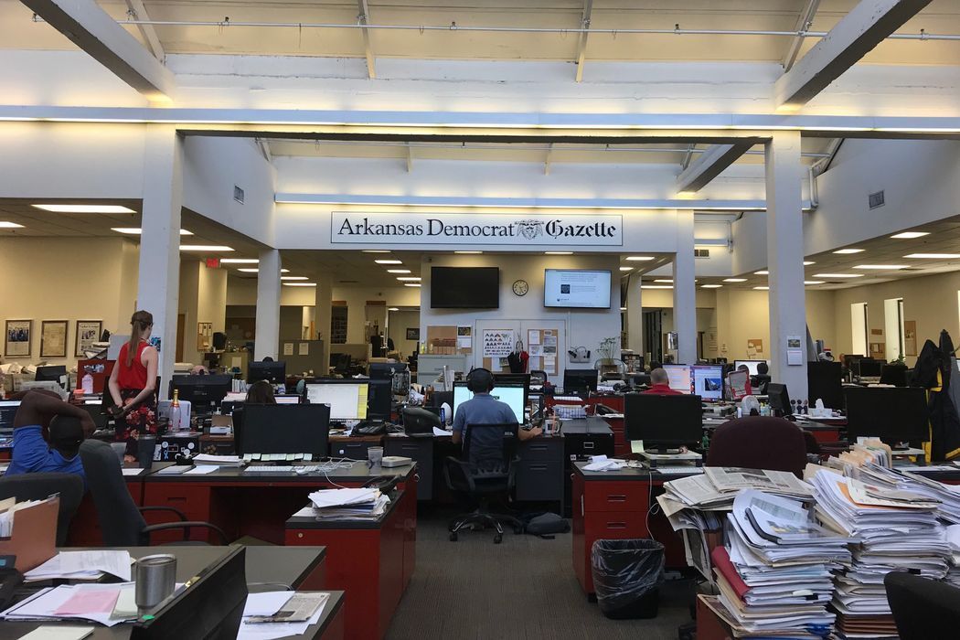A large office with lots of people sitting at desks