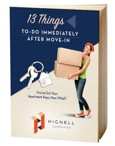 A woman is carrying a stack of boxes and keys.