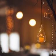 Warm hanging glass pendant lights glowing in a softly blurred indoor setting