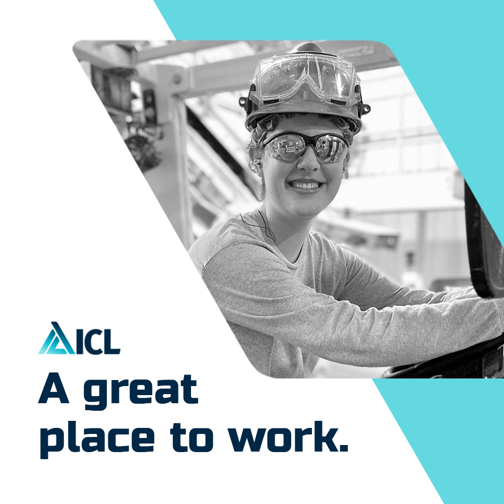 a black and white photo of a woman wearing a hard hat and goggles .