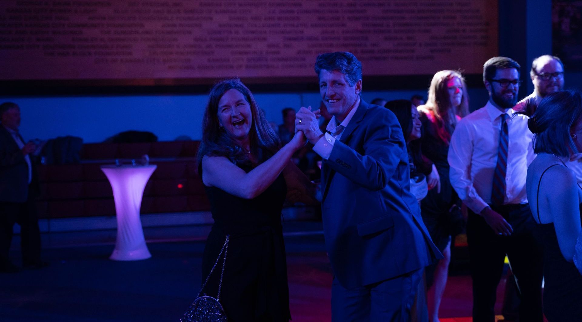 Professional photograph of a big party with a band and people are dancing.