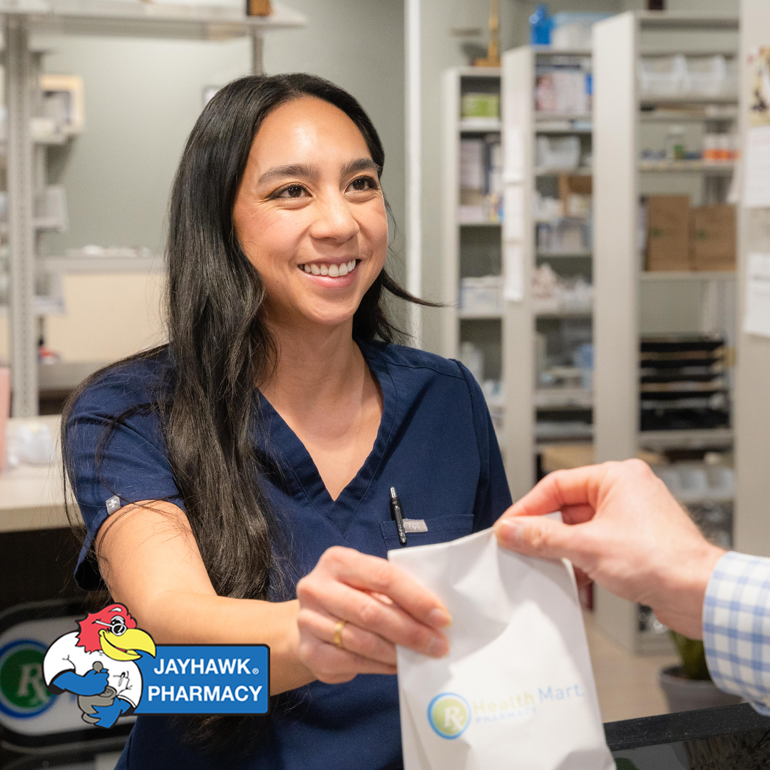 Professional photograph of a woman working at Jayhawk pharmacy taken by KMG.