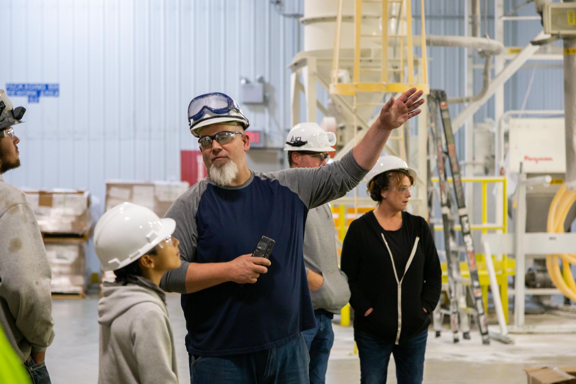 Professional photograph of people being shown around a factory.