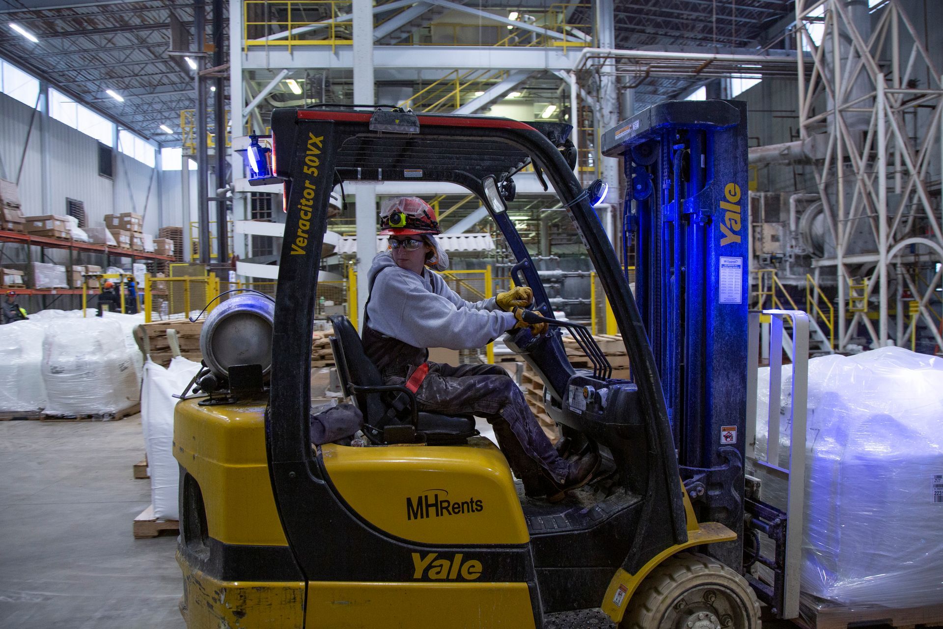 Professional photograph of a man driving a fork lift.