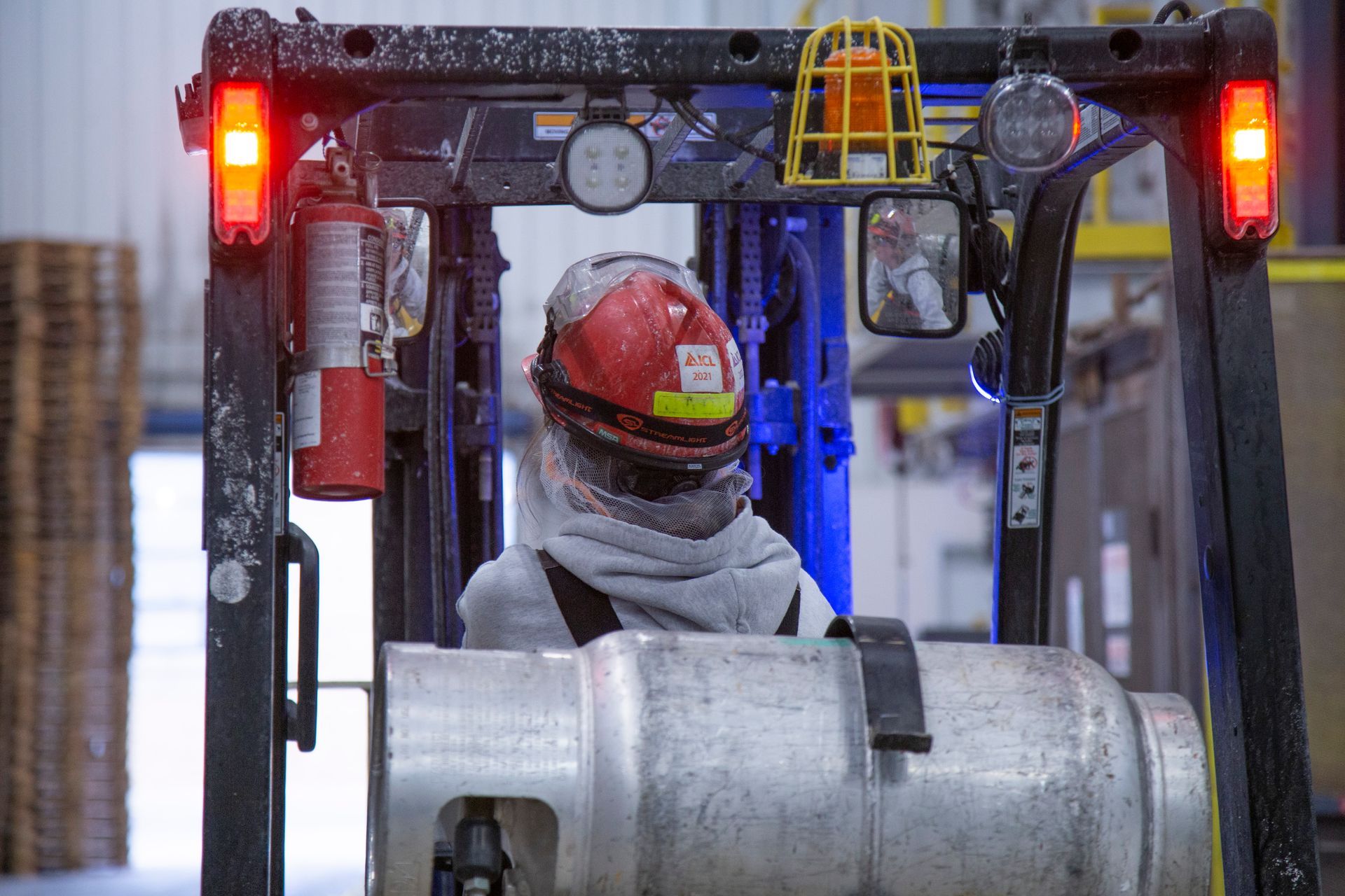 Professional photograph of a person working with large machinery.