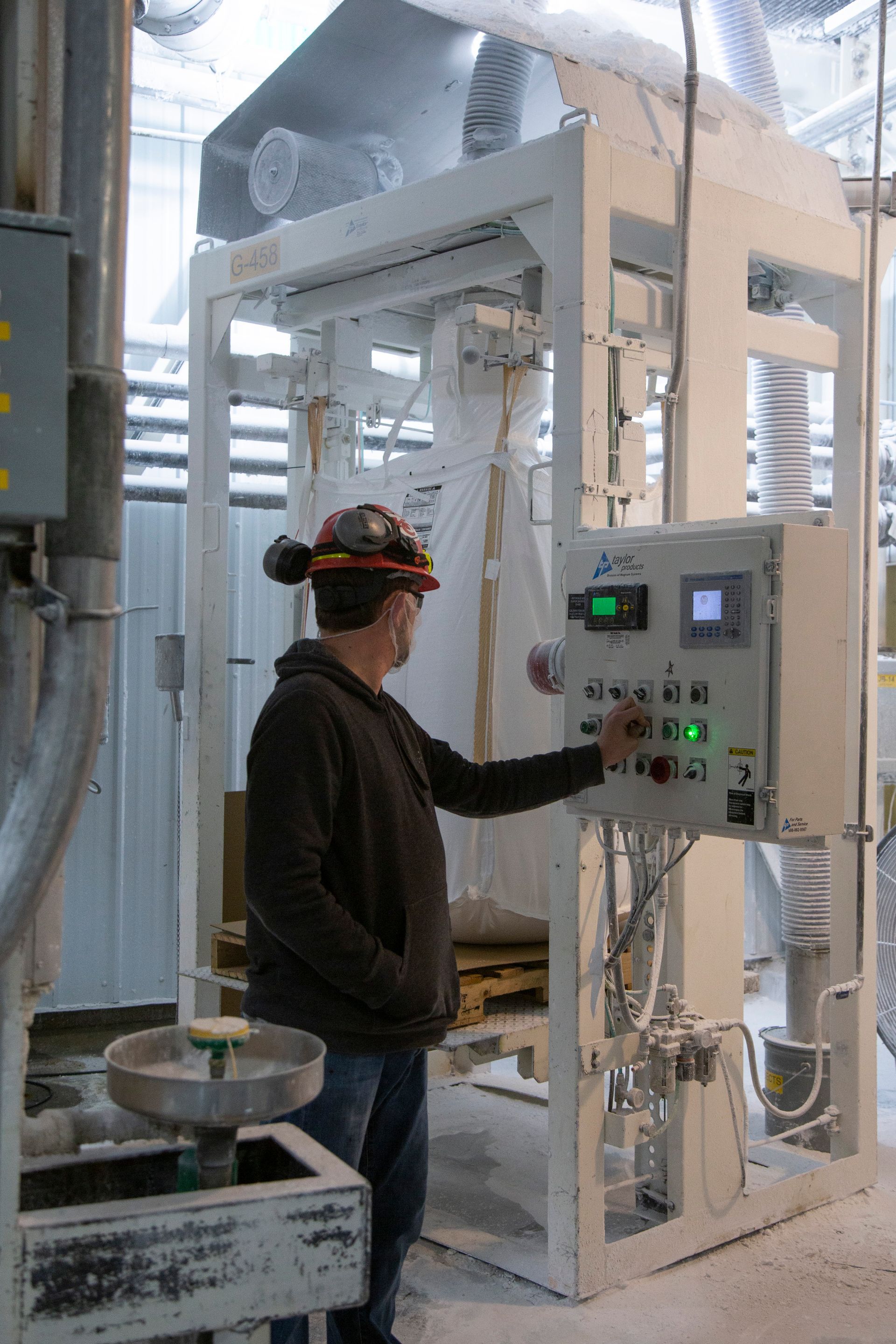 Professional photograph of a man making adjustments on a power panel.