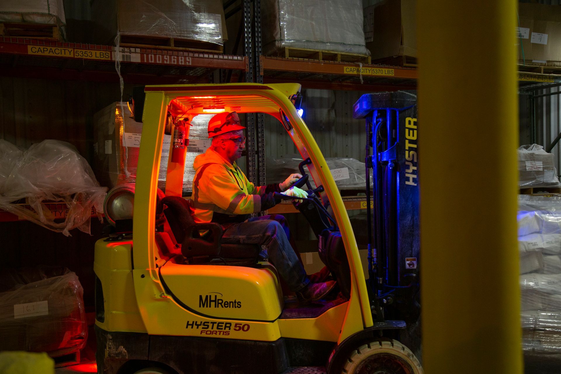 Professional photograph of a person sitting in a loader to move stock.
