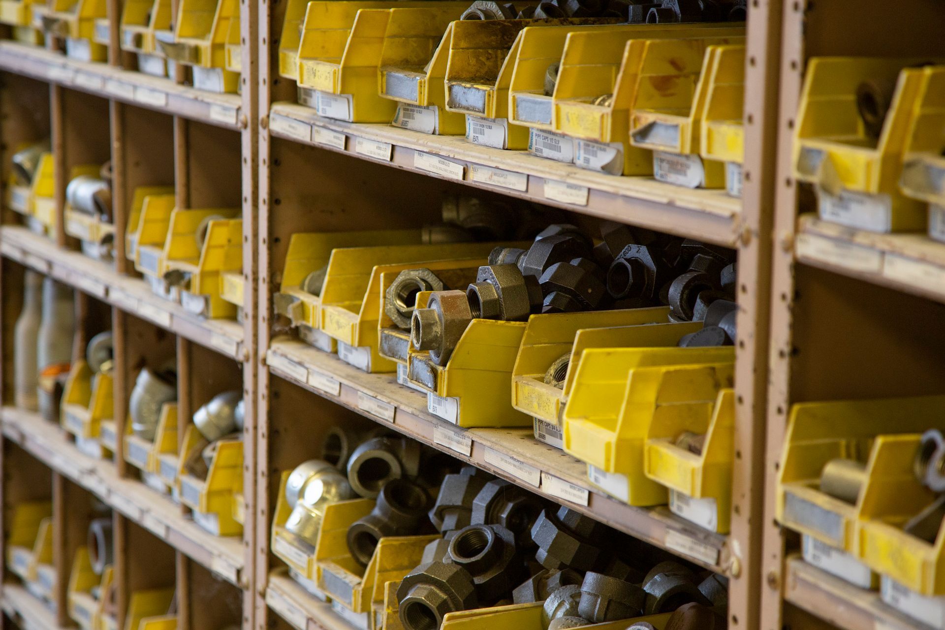 Professional photograph of a wall of small parts organized in cubbies.