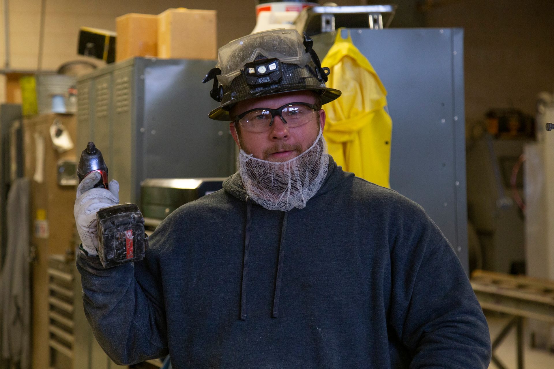 Professional photograph of a man standing in a factory.