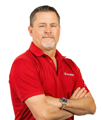 a man in a red shirt is standing with his arms crossed