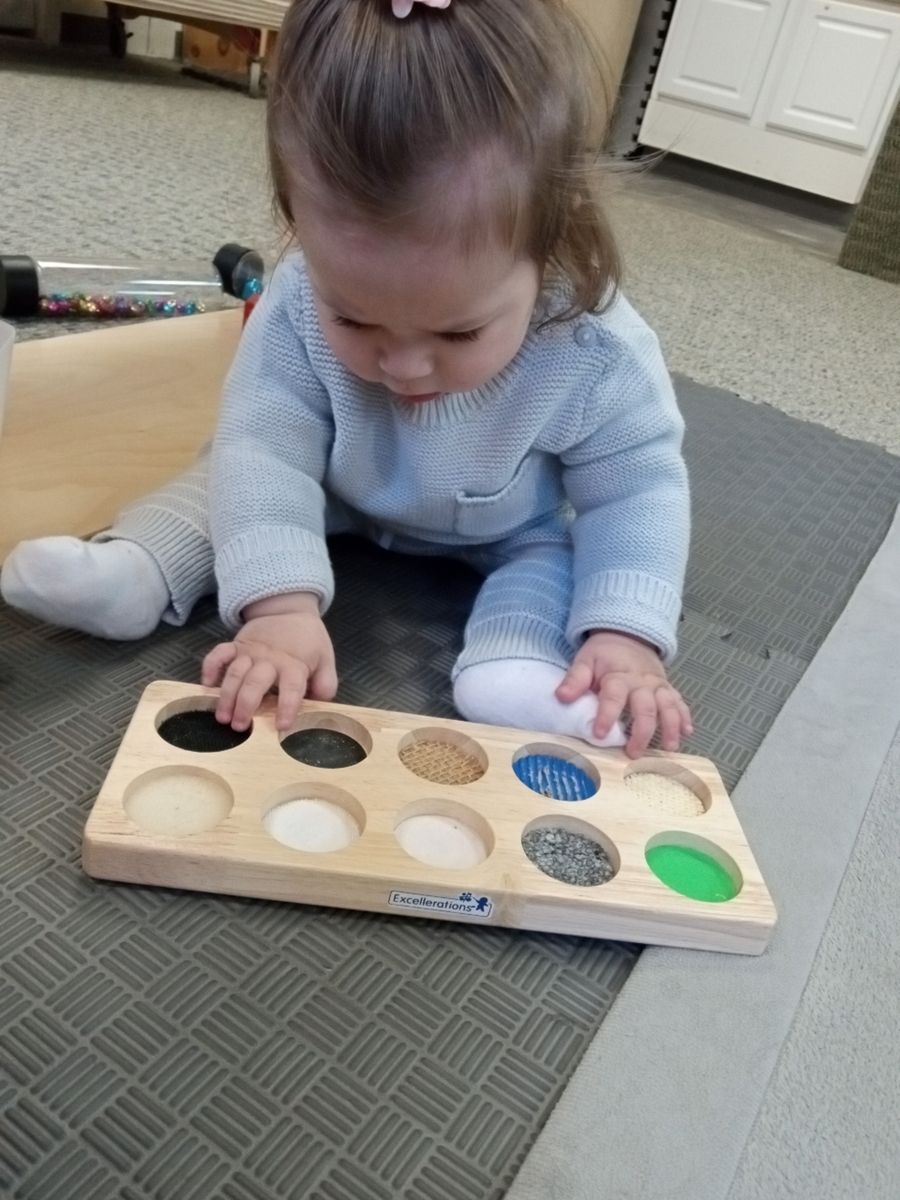 Infant working with Montessori sensory material