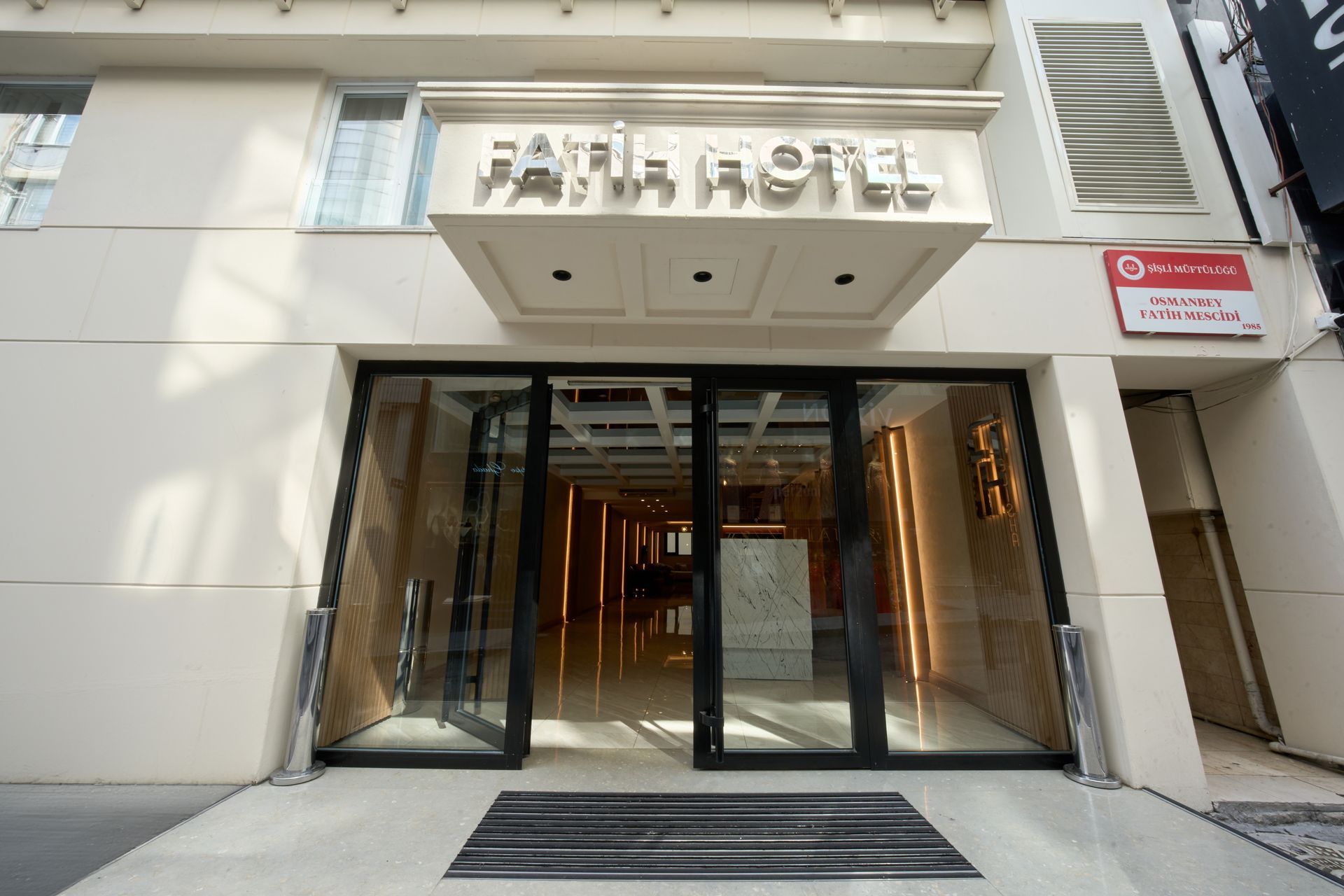 The entrance to a hotel with a large glass door