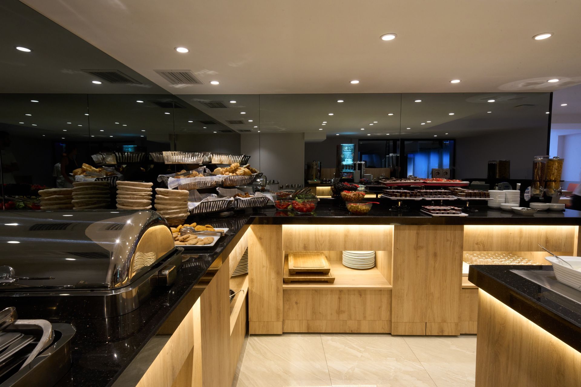 A buffet area in a restaurant with a lot of food on the counters.