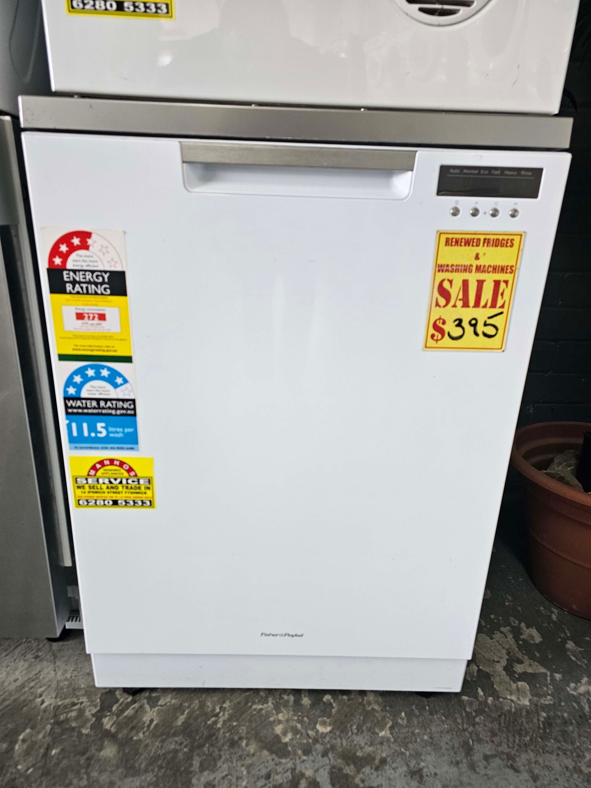 White mini refrigerator with sale stickers in an appliance store display.
