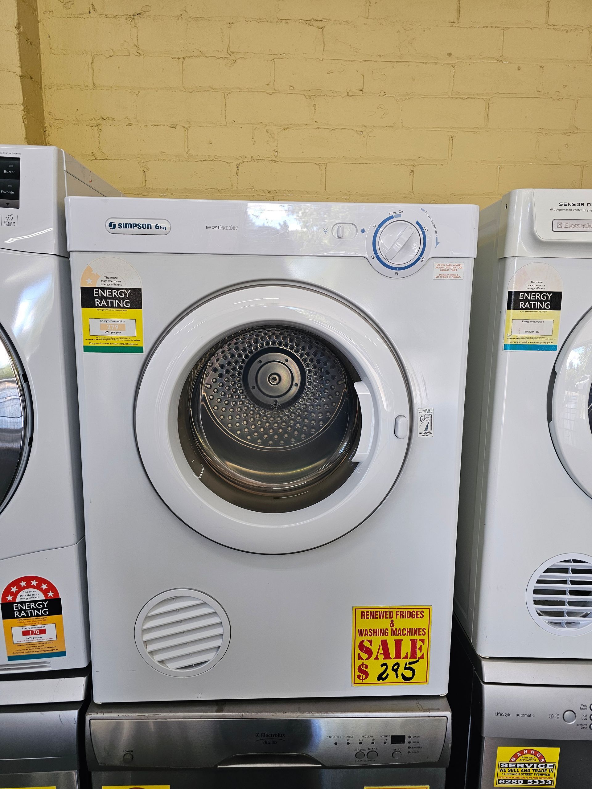 A washer and dryer are sitting next to each other in a laundromat.