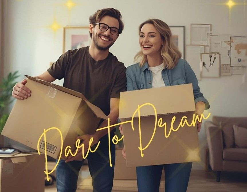 Smiling couple holding moving boxes in a living room with the words “Part to Dream” overlaid.