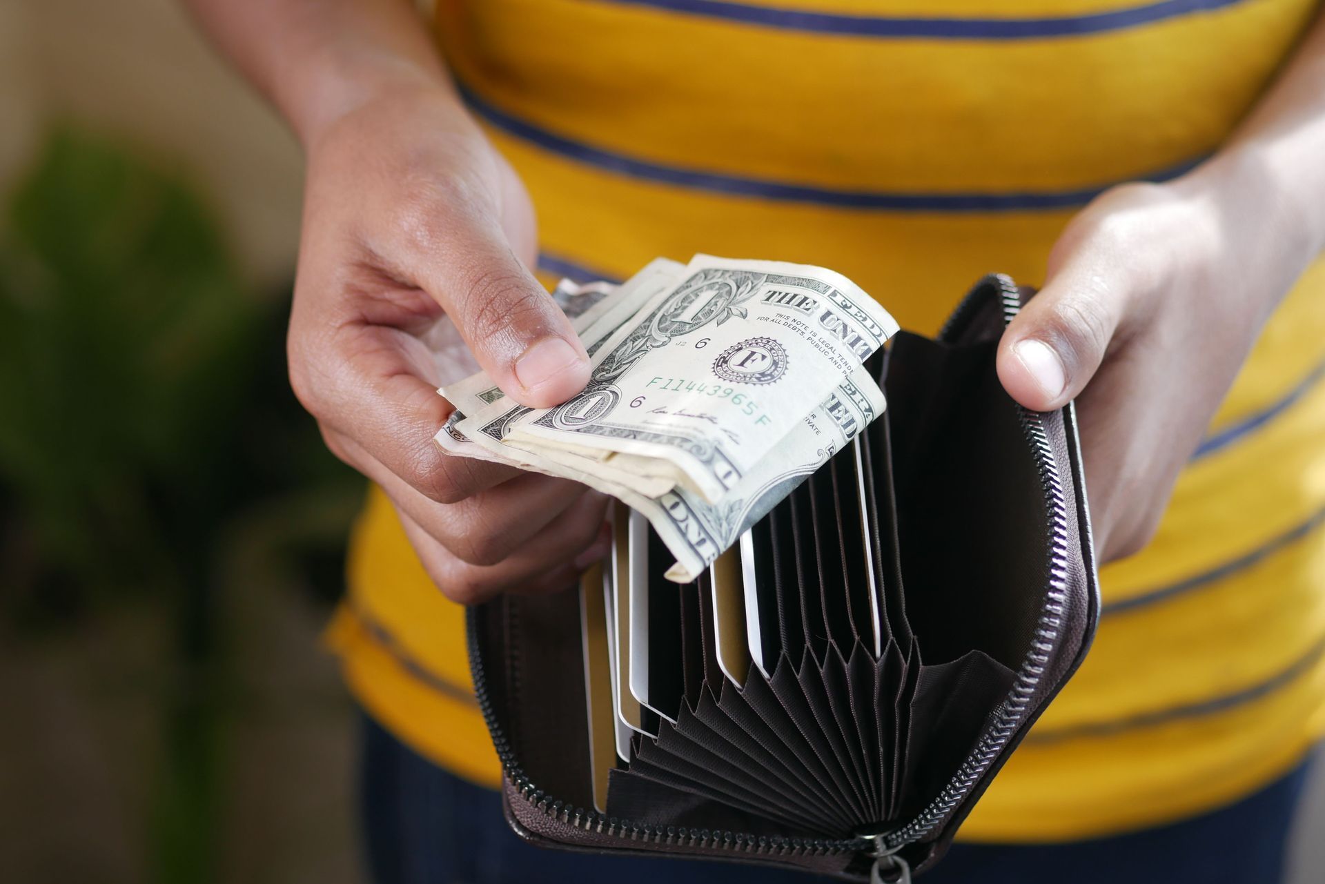 Women with open wallet, holding money, representing spending & saving