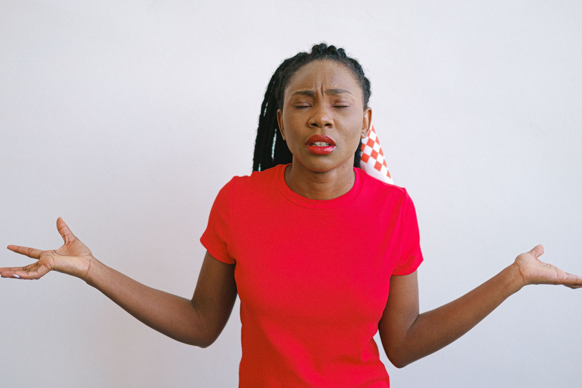 Woman shrugging her shoulders while considering what to do when a house is not selling