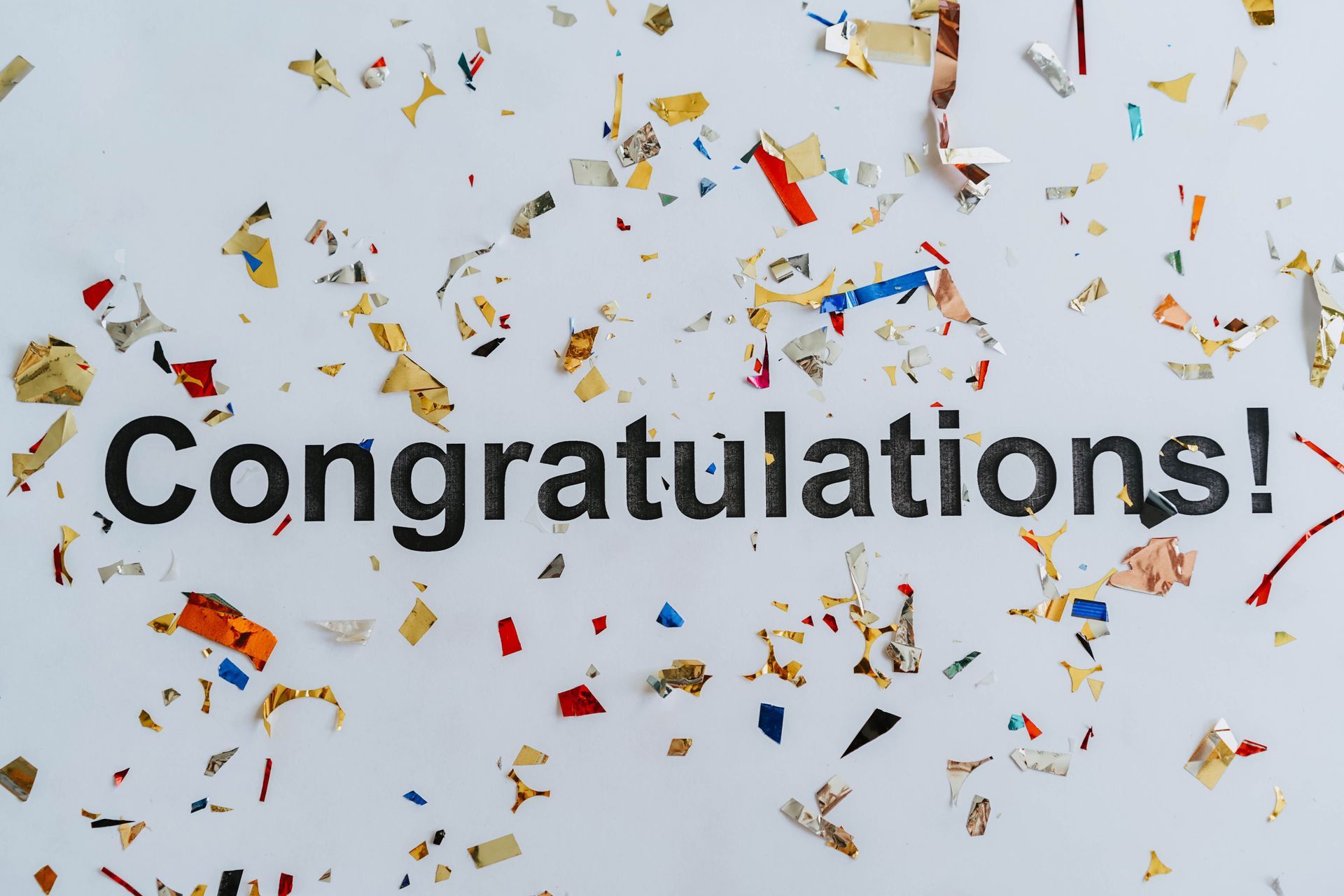 Congratulations with confetti celebrating a seller after closing on their home
