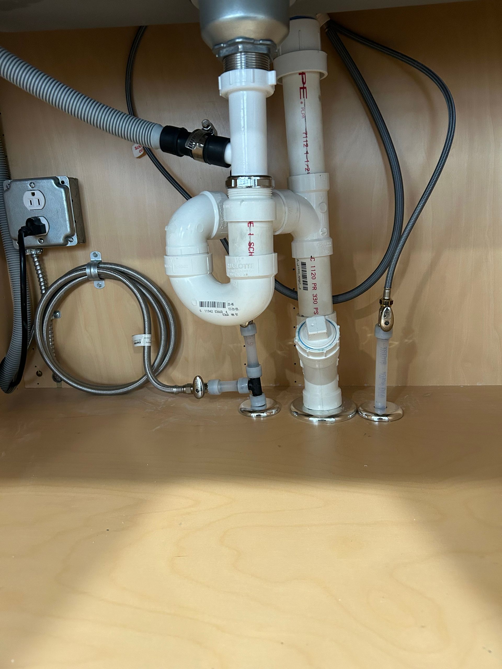 A sink with a lot of pipes underneath it