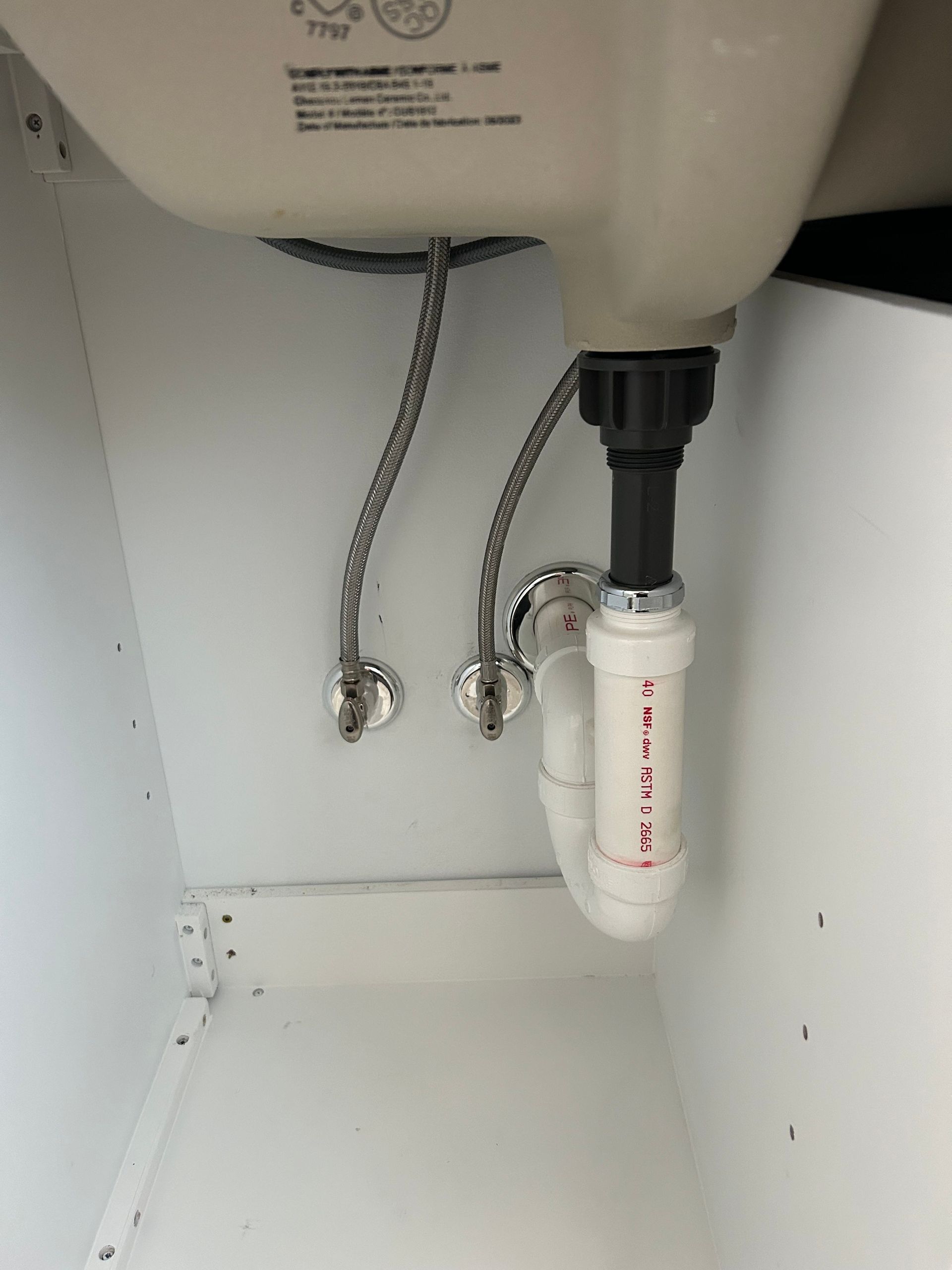 A bathroom sink with a hose attached to it