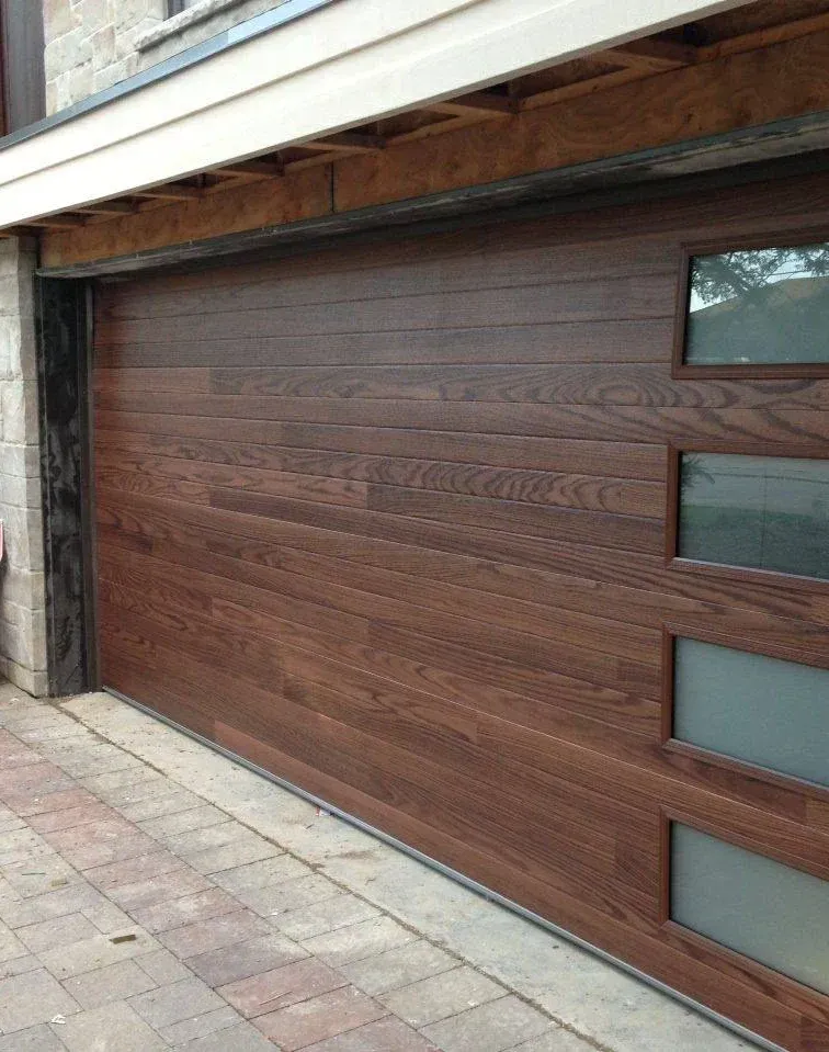 A wooden garage door with a window on the side of it
