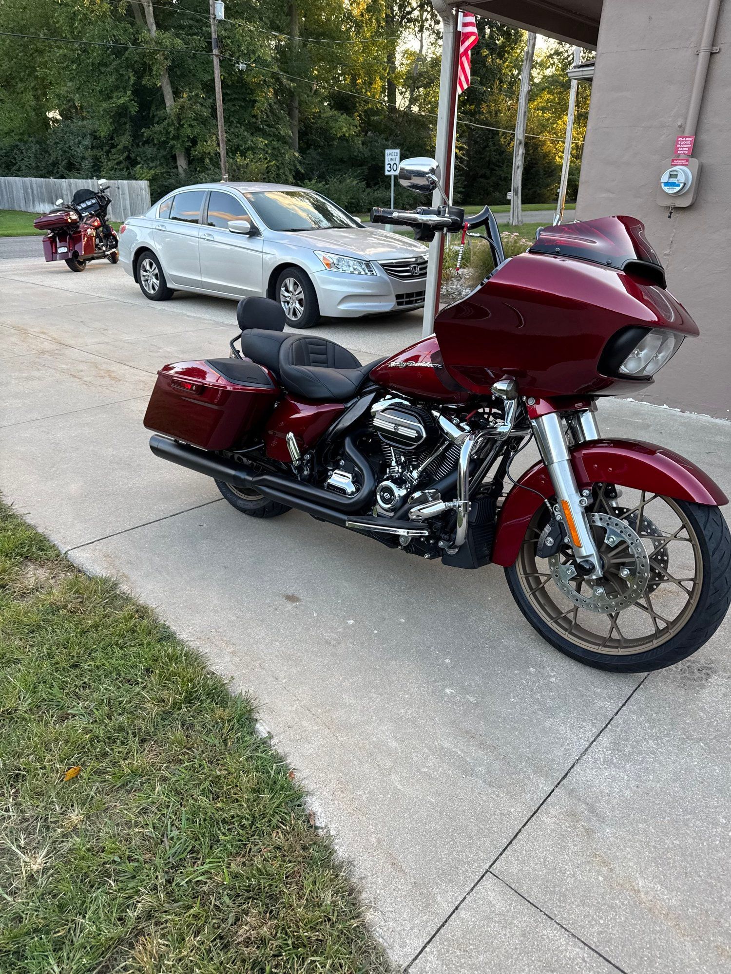 Blue touring motorcycle parked in a garage beside wooden cabinets and tools