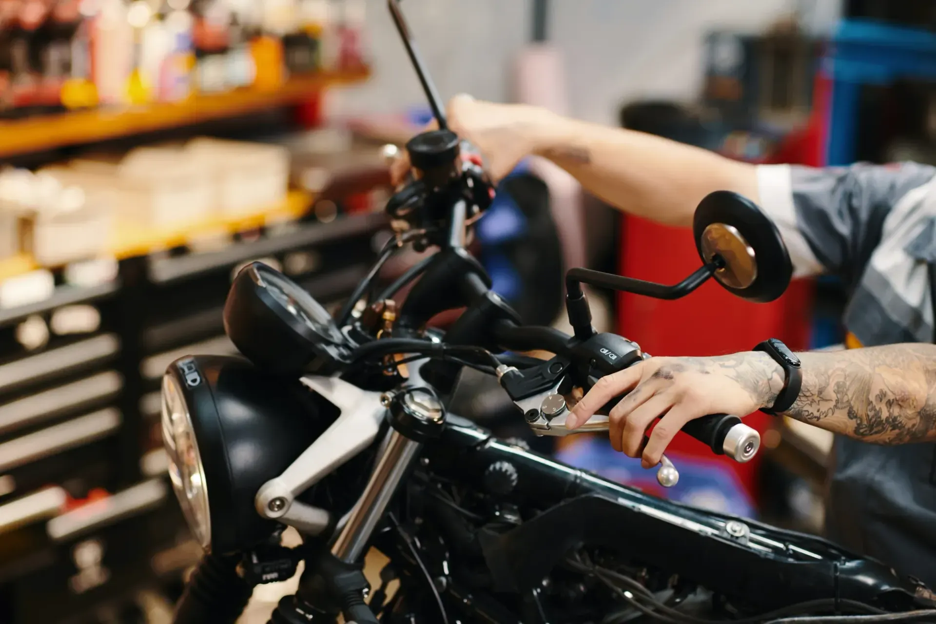 Blue touring motorcycle parked in a garage beside cabinets and tools