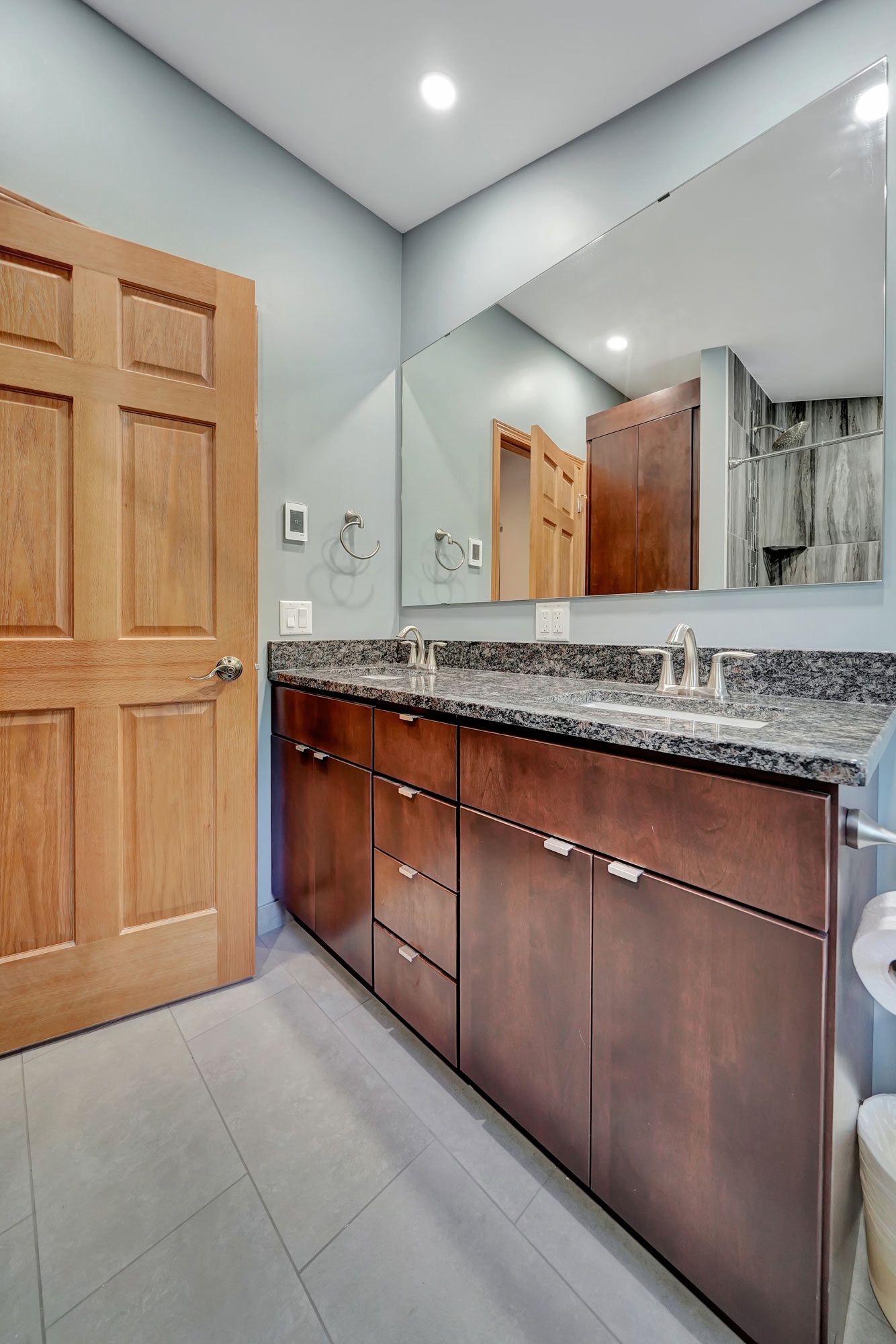 Bathroom With Two Sinks And A Large Mirror | Lincoln, NE | SkyLimit Remodeling