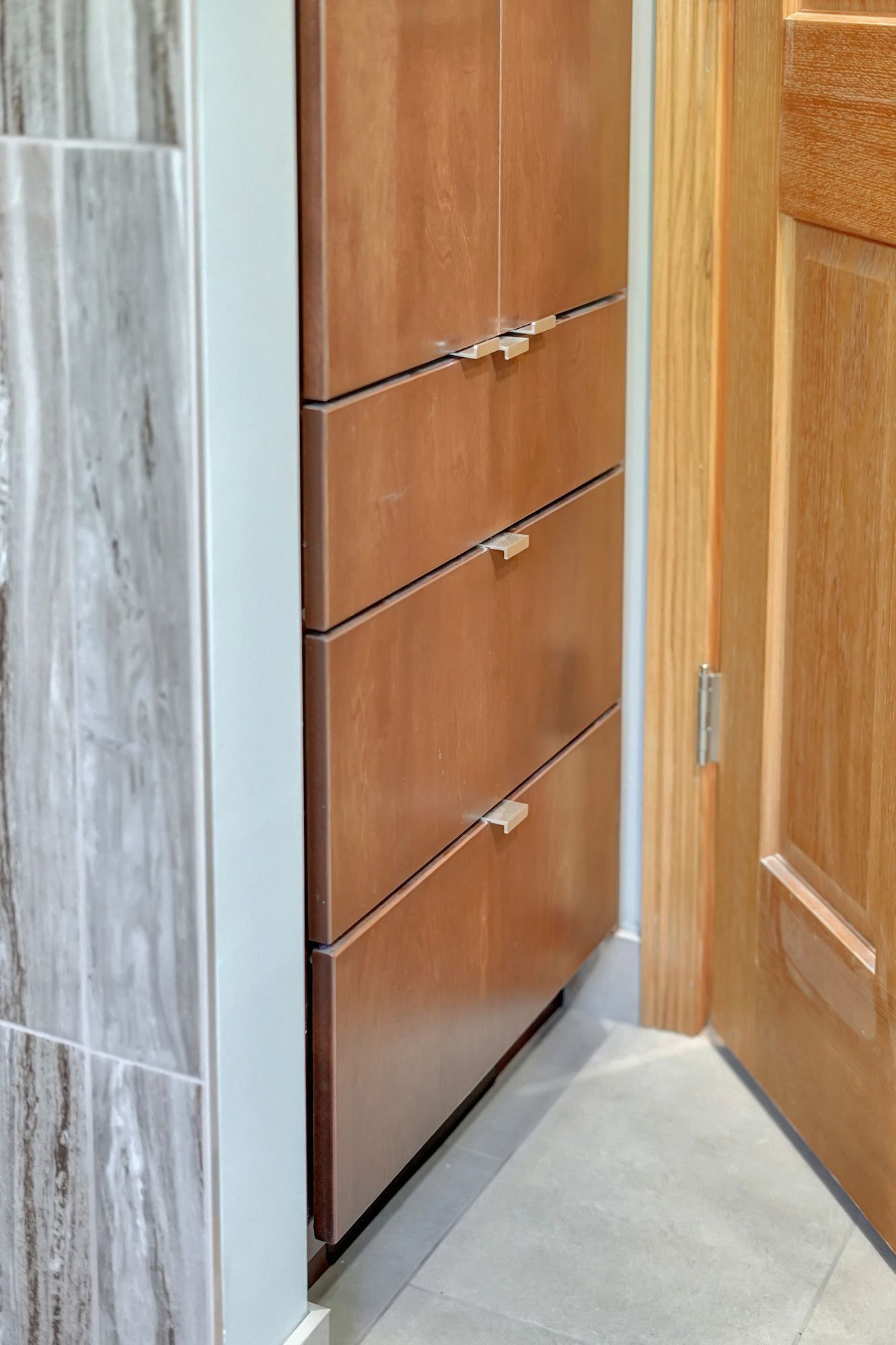 Bathroom With A Wooden Cabinet And A Wooden Door | Lincoln, NE | SkyLimit Remodeling