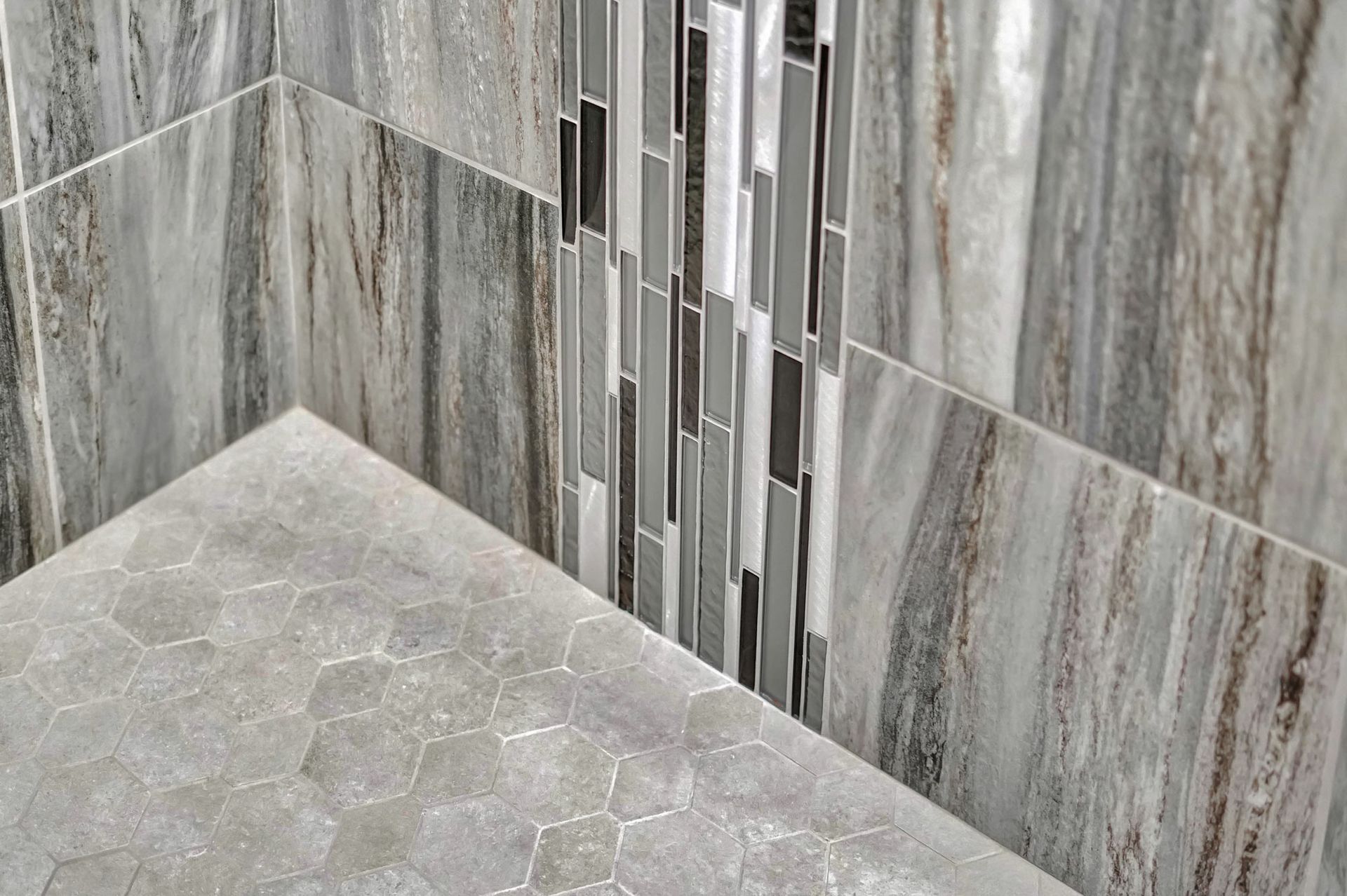 Close Up Of A Shower With Marble Tiles On The Wall And Floor | Lincoln, NE | SkyLimit Remodeling