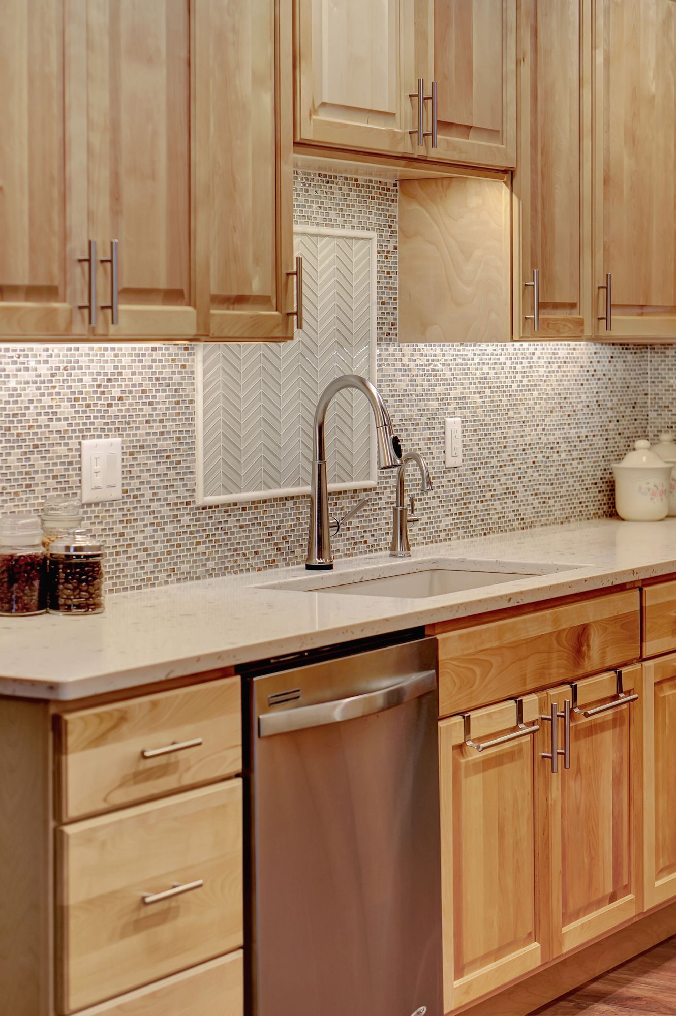 A Kitchen with Wooden Cabinets and a Stainless Steel Dishwasher | Lincoln, NE | SkyLimit Remodeling