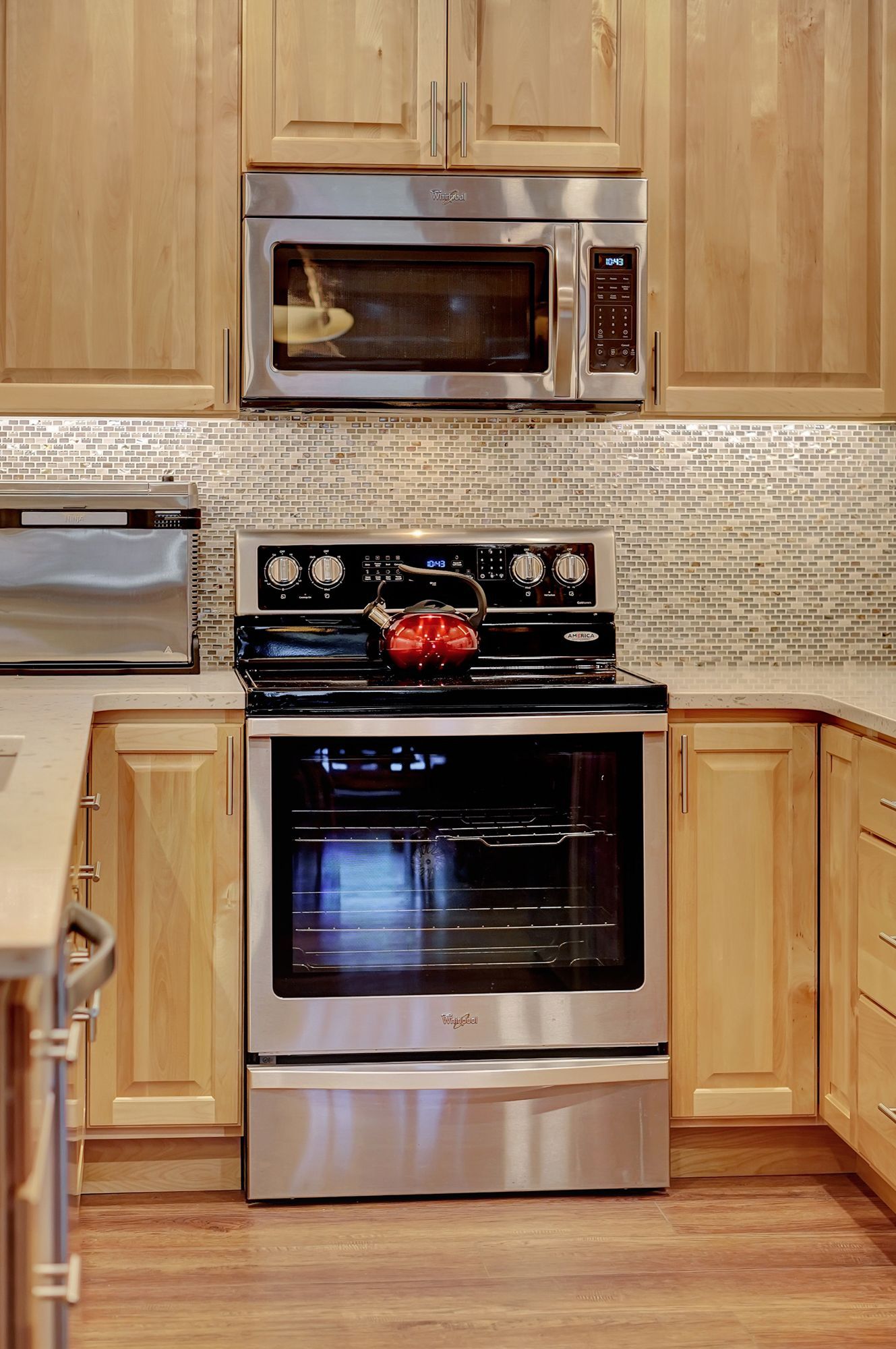 A Kitchen with Stainless Steel Appliances and Wooden Cabinets | Lincoln, NE | SkyLimit Remodeling
