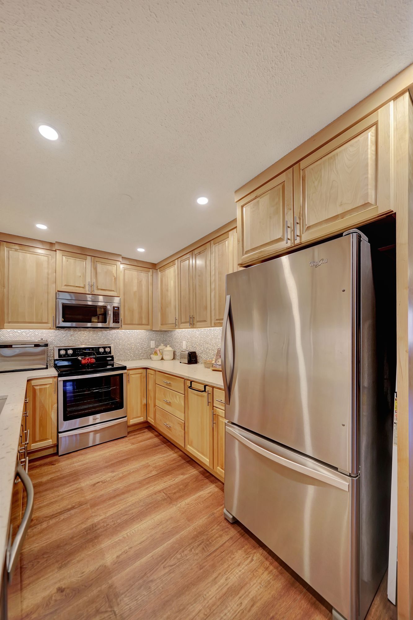 A Kitchen with Stainless Steel Appliances and Wooden Cabinets | Lincoln, NE | SkyLimit Remodeling