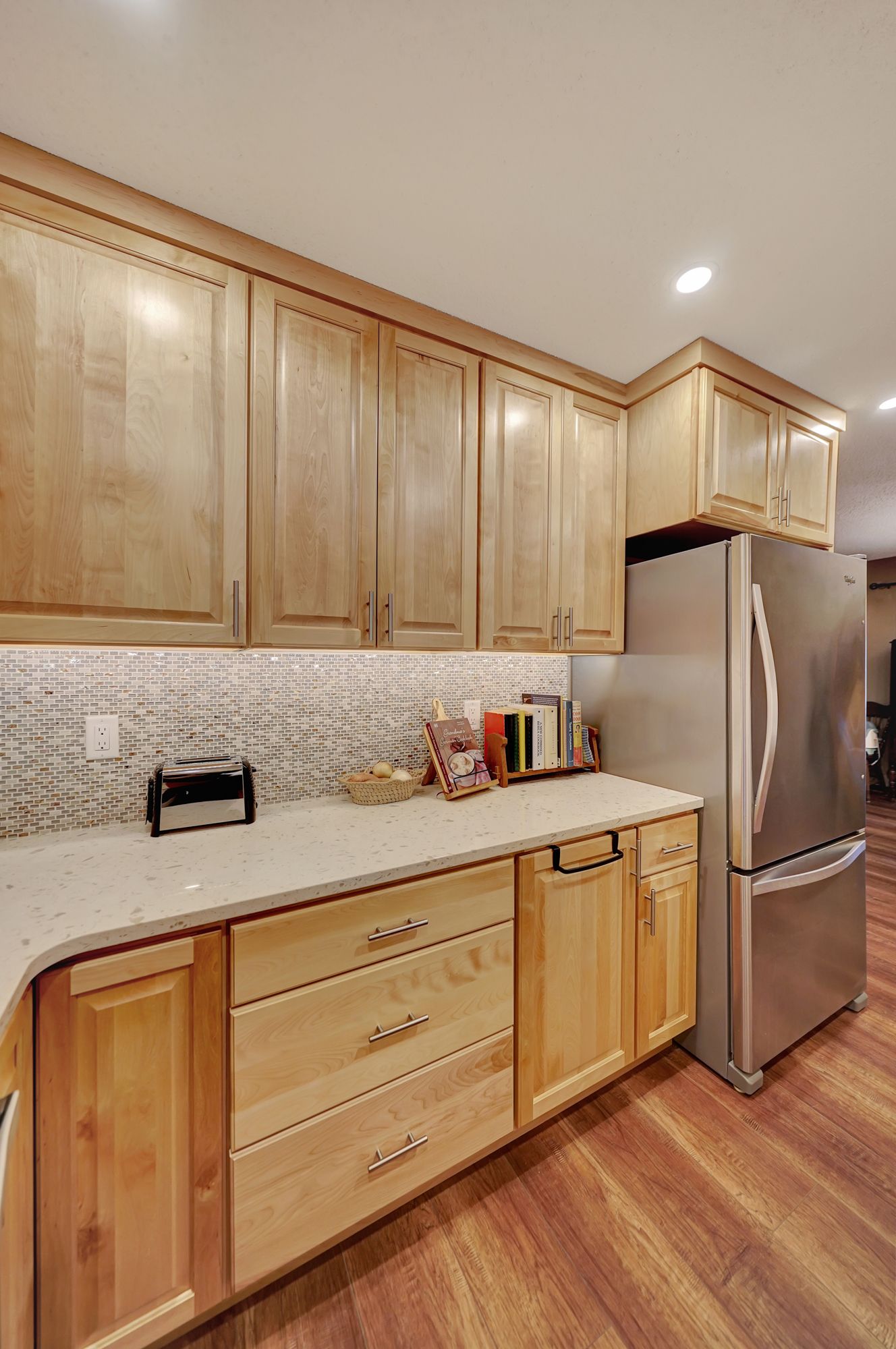 A Kitchen with Wooden Cabinets and a Stainless Steel Refrigerator | Lincoln, NE | SkyLimit Remodeling