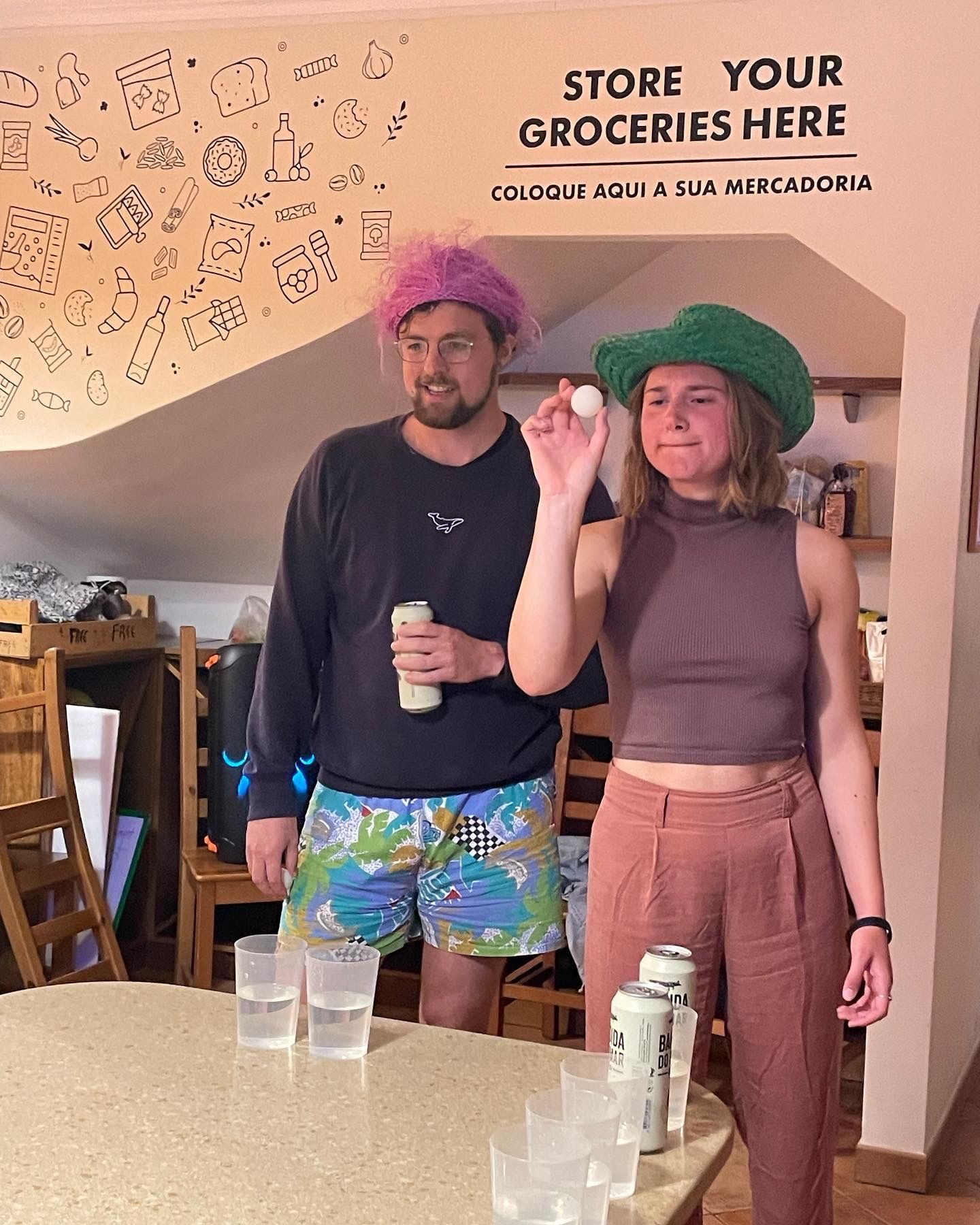 A man and a woman are standing in front of a sign that says store your groceries here