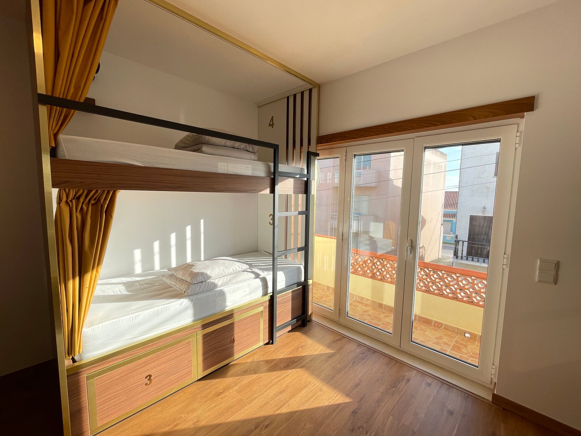 A bunk bed in a room with a sliding glass door.