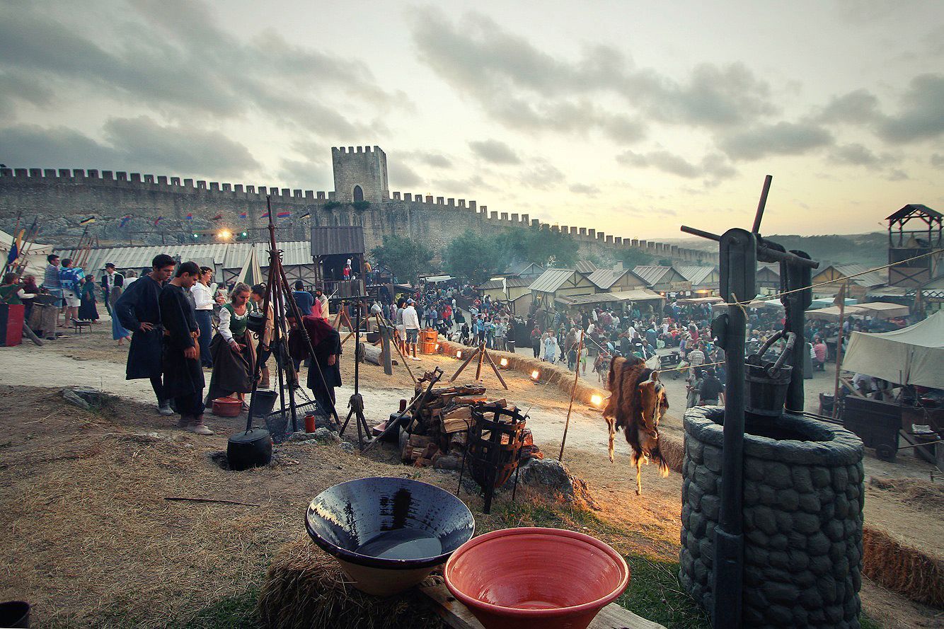 A group of people are standing in front of a castle.