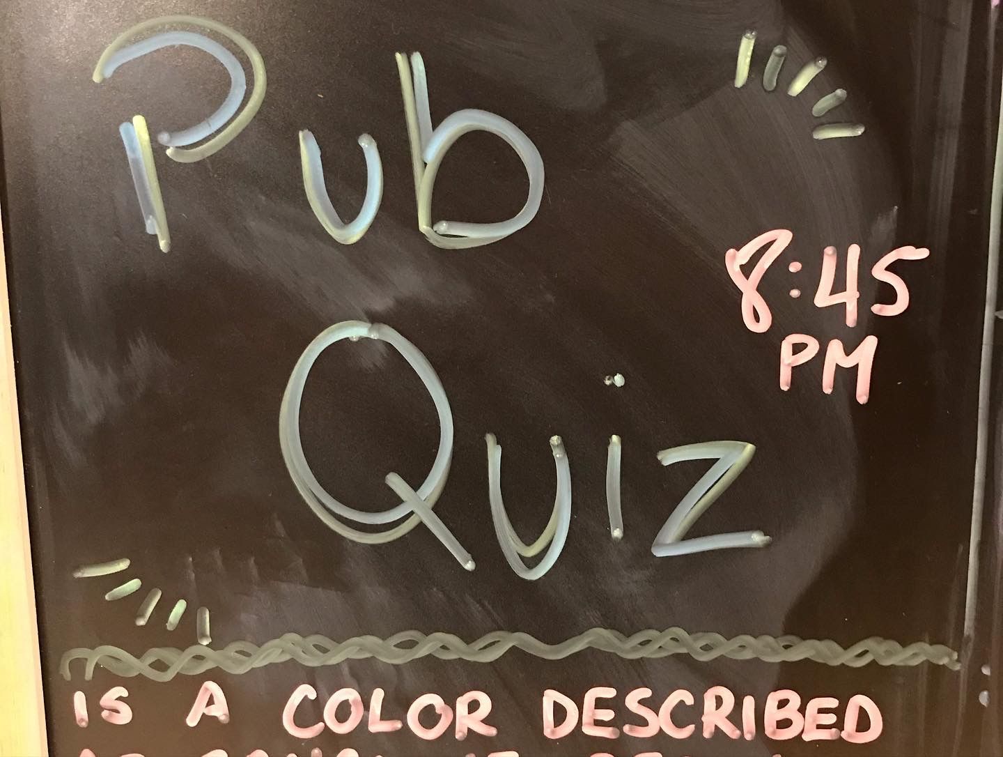 A blackboard with the words pub quiz written on it