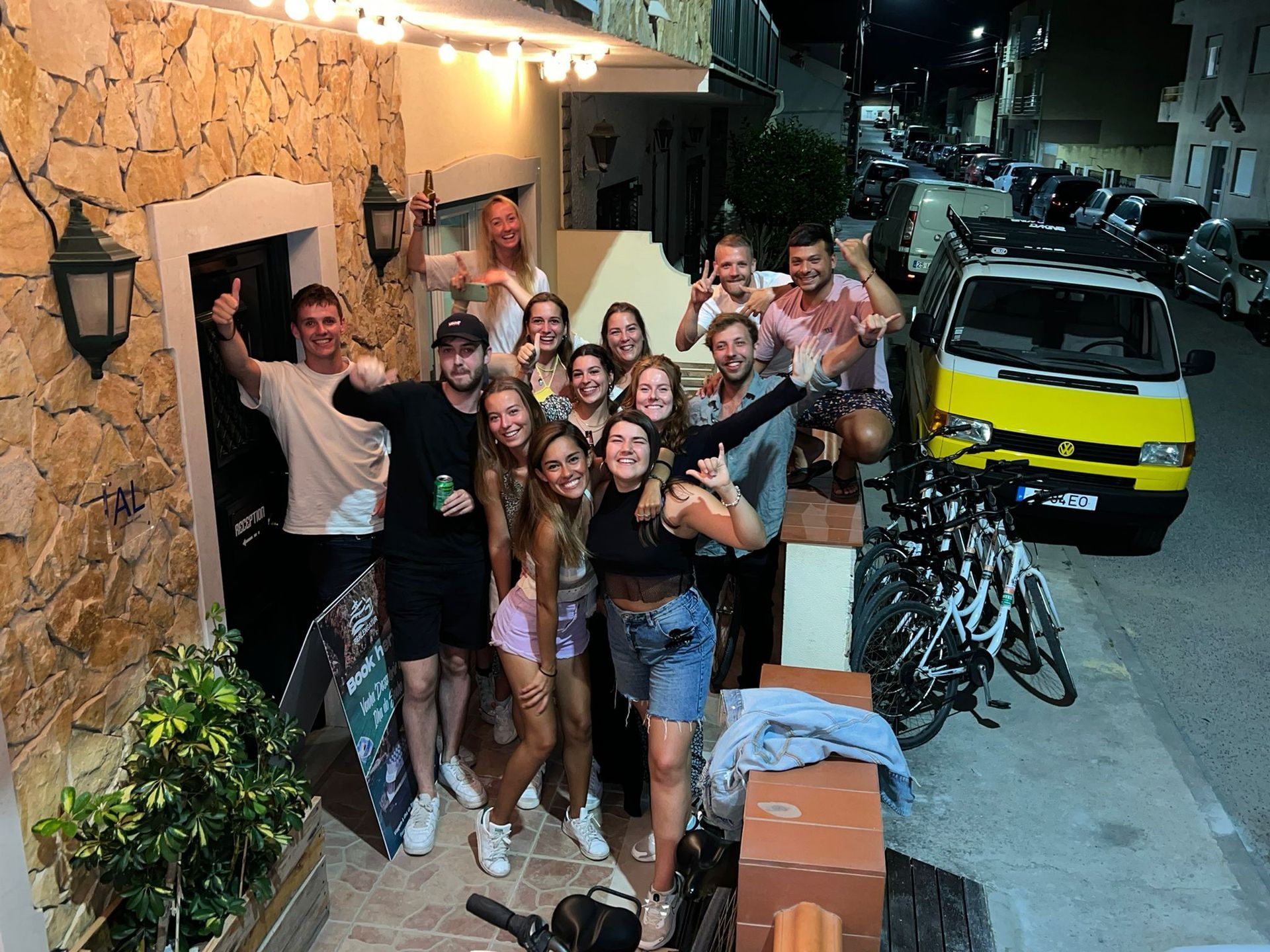 A group of people are posing for a picture in front of a building.
